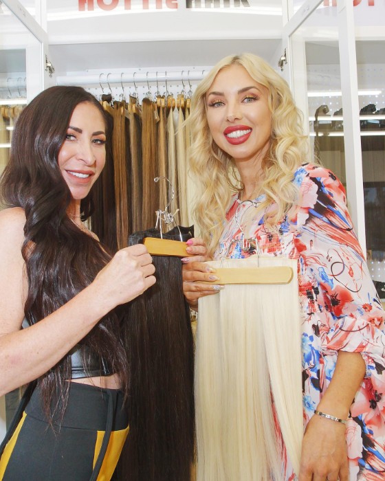 Stylist Showing Examples of Hair Extensions in Stock