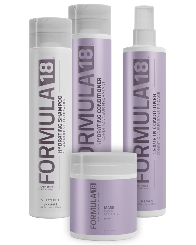 Formula 18 Plant-Based Reinforcement Additive, Hydrating Shampoo, and Leave-In Conditioner arranged on a modern salon shelf, showcasing professional hair care products for strengthening and revitalizing damaged hair.