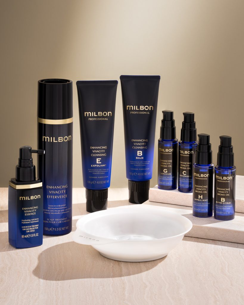 MILBON Enhancing Vivacity professional hair care products, including Vivacity Shampoo, Treatment, and Essence, elegantly arranged on a salon display, designed to boost hair vibrancy and shine.